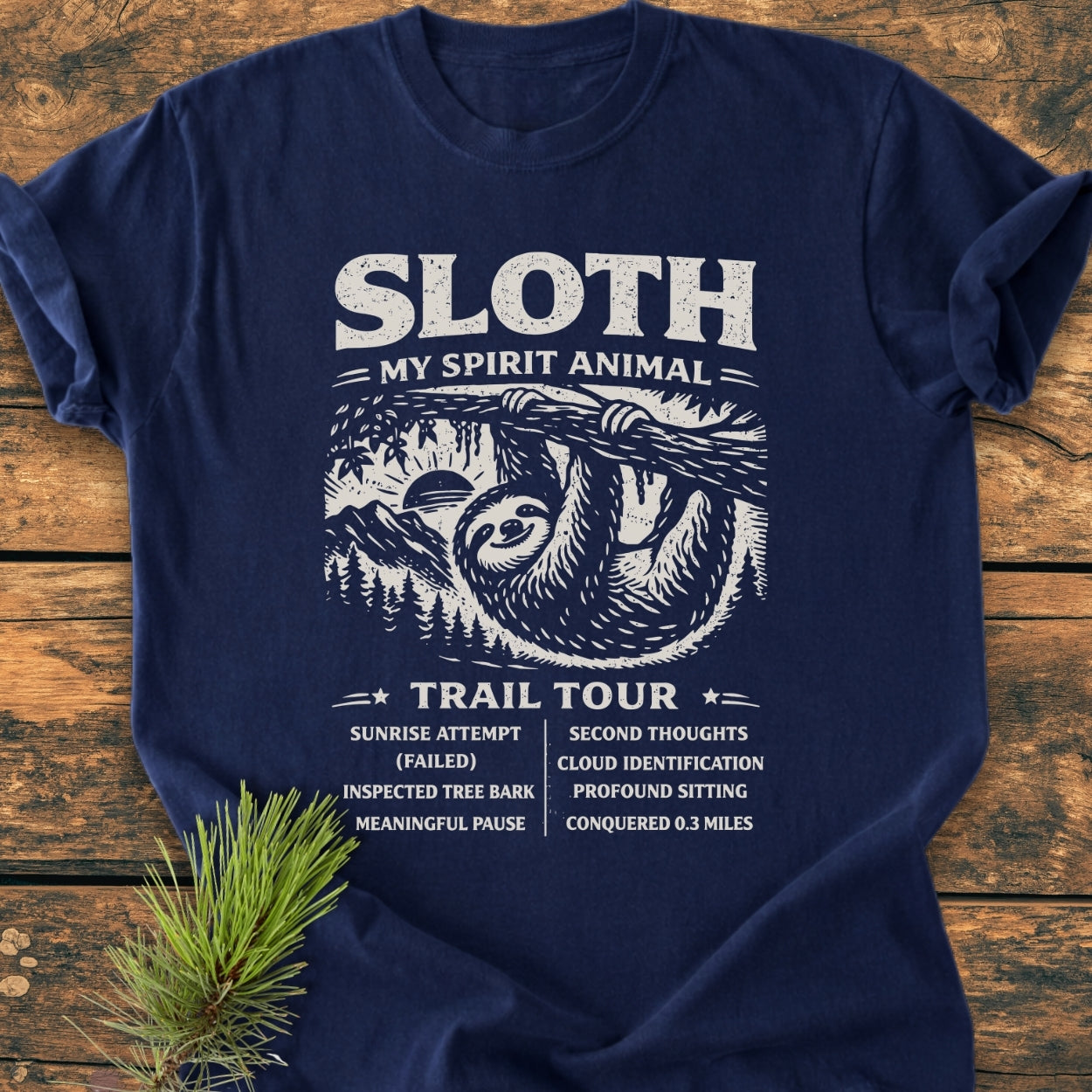 Sloth Spirit Animal Tour - Vintage Wash Tee features a whimsical sloth illustration with humorous adventure bullet points, displayed on a navy-blue T-shirt, emphasizing comfort and durability with a relaxed fit.