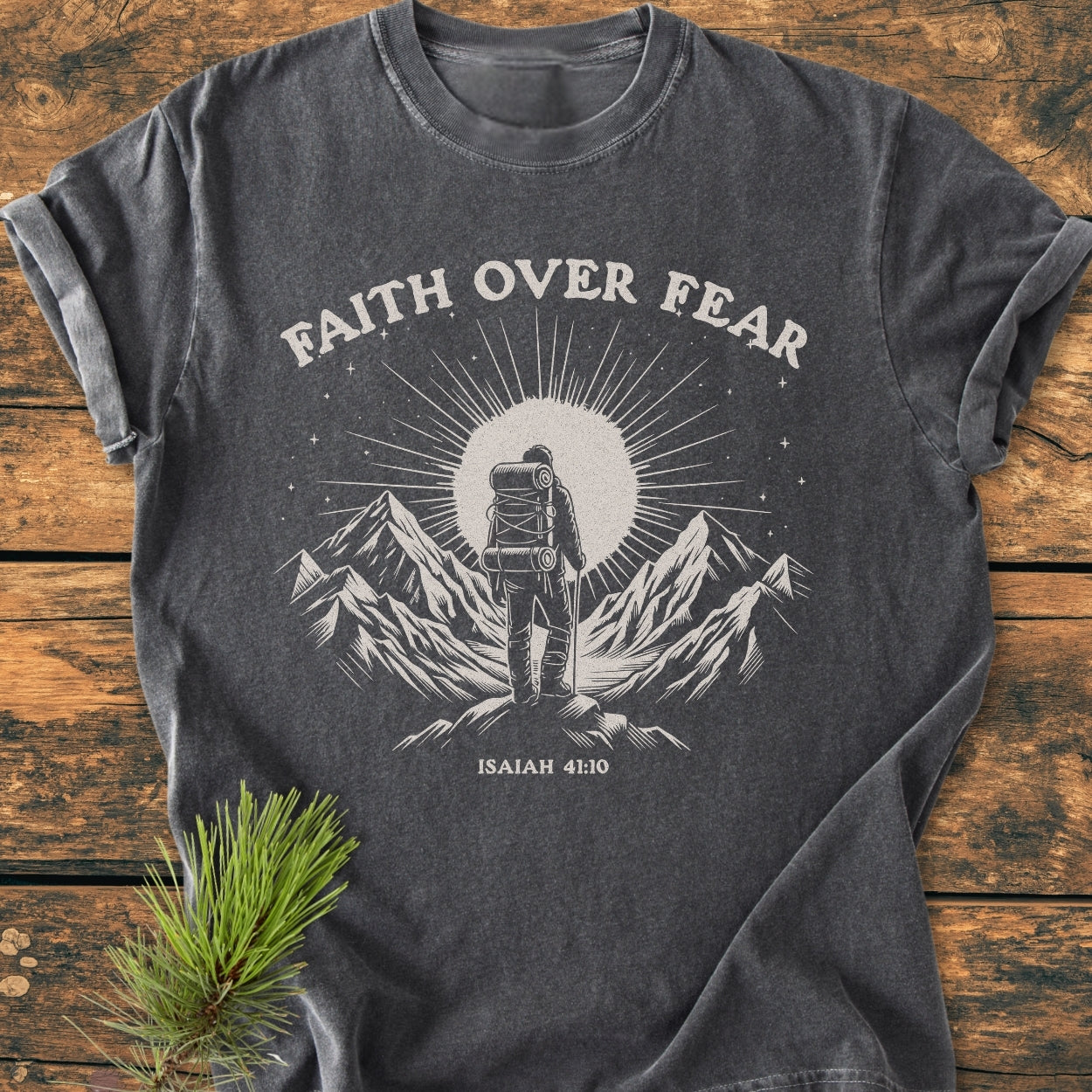 Faith Over Fear - Vintage Wash Tee features a lone hiker print with a sunburst and scripture, offering a relaxed fit and soft-washed comfort in 100% ring-spun cotton.