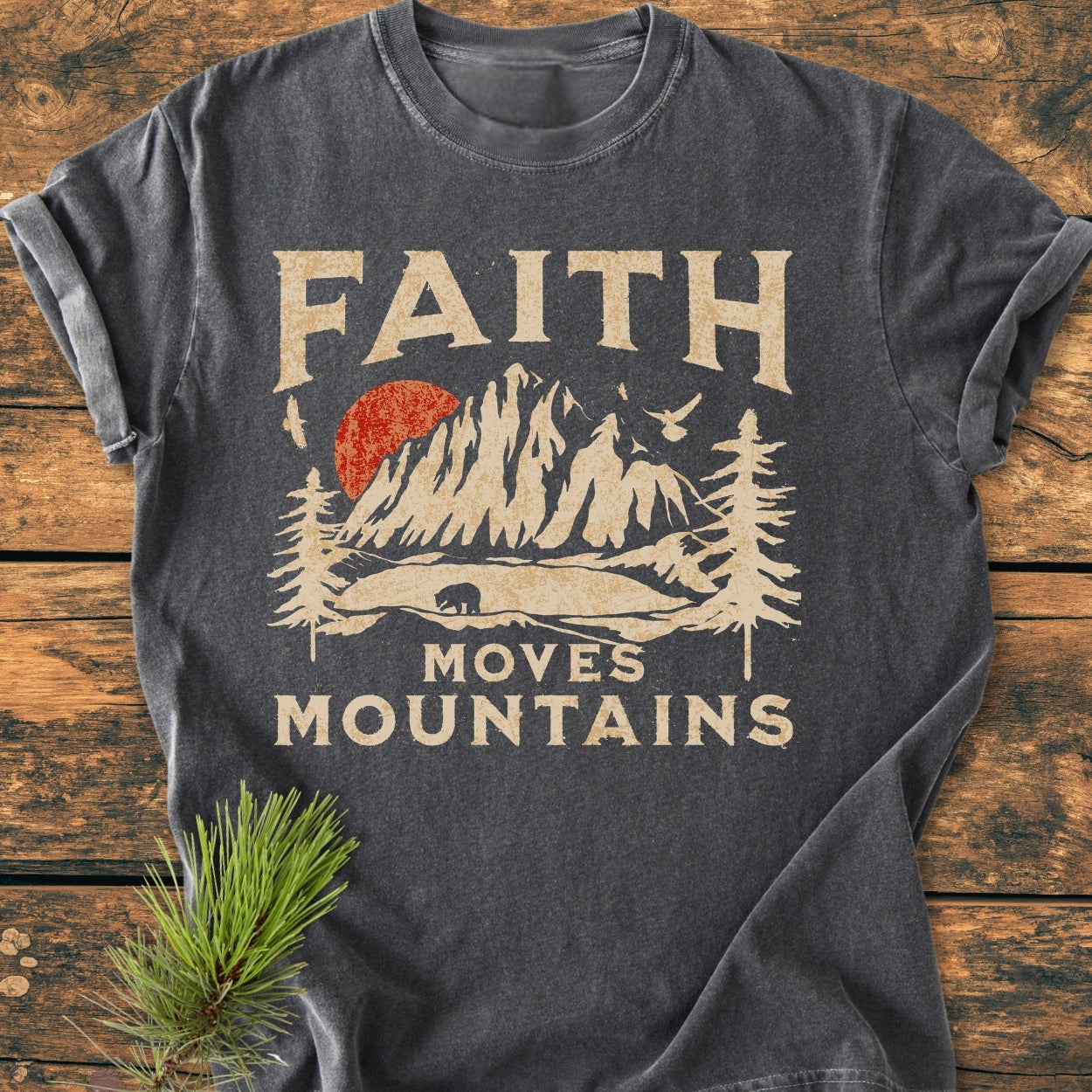 Faith Moves Mountains - Vintage Wash Tee features a stylized mountain scene with a bear and birds, emphasizing durability and comfort with its relaxed fit and garment-dyed fabric.