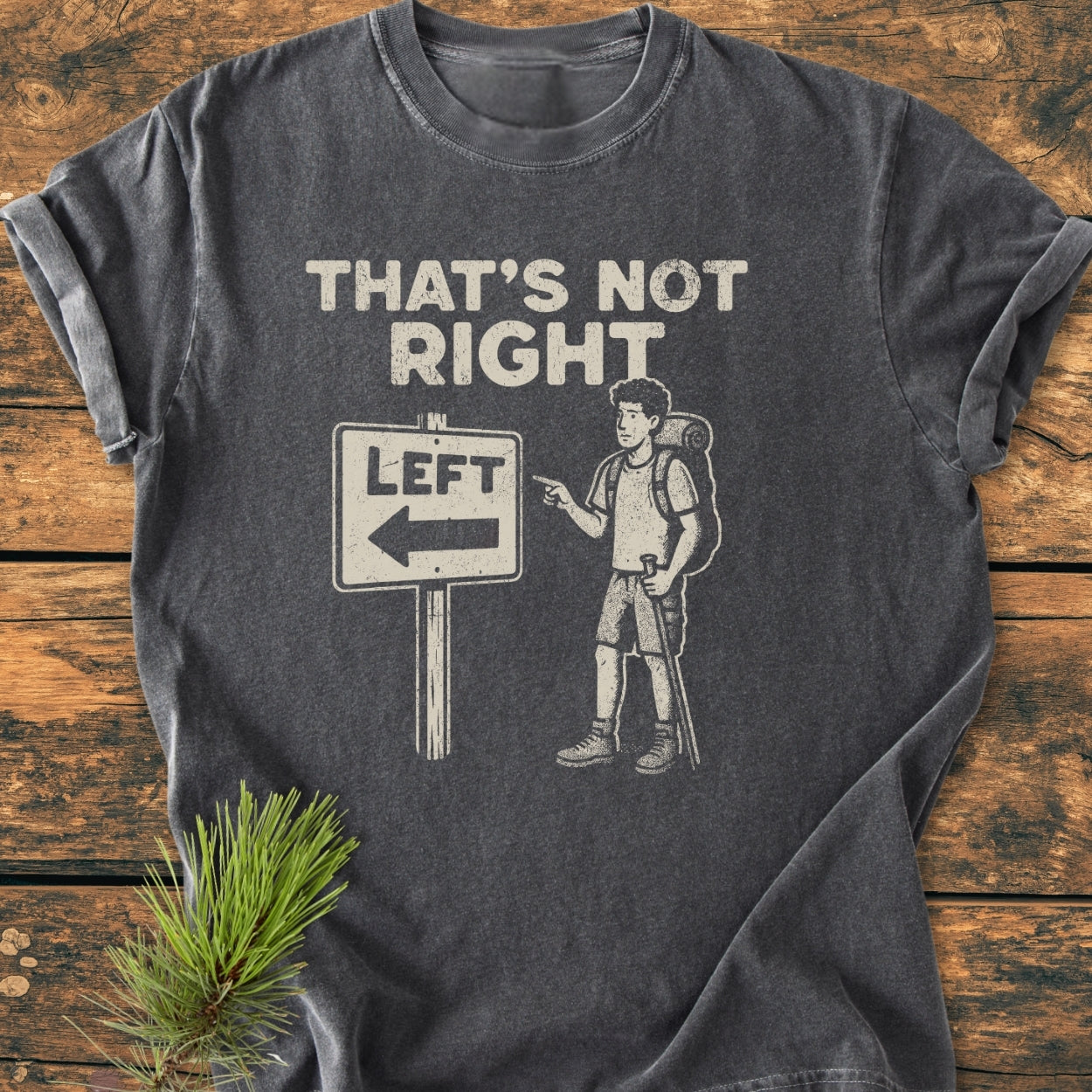 That's Not Right - Vintage Wash Tee showcases a cartoon hiker and humorous road sign graphic on a charcoal-gray T-shirt, highlighting its relaxed fit and durable construction.