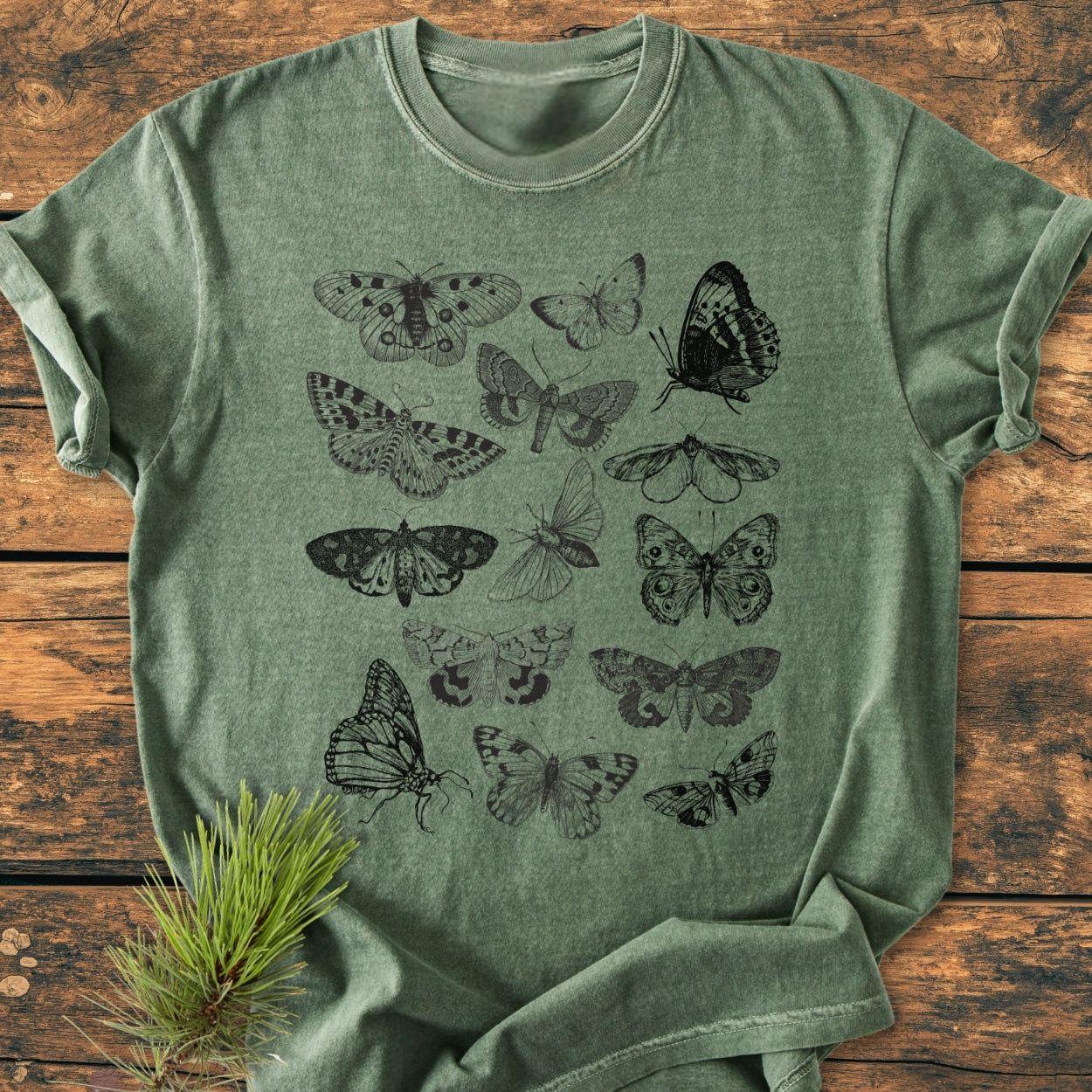 Vintage Butterfly Tattoo - Vintage Wash Tee displayed flat, showcasing stylized butterfly and moth prints. Made from soft, garment-dyed fabric, it features a relaxed fit with durable double-needle stitching.