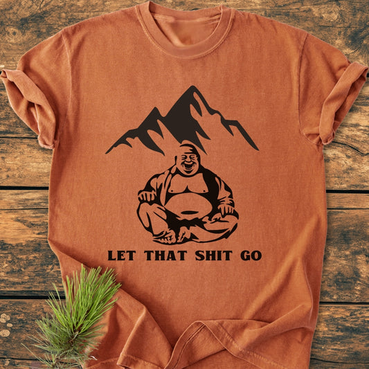 Let That Shit Go - Vintage Wash Tee: A folded T-shirt with a seated Buddha graphic and bold text. Made from soft, durable, pre-shrunk ring-spun cotton for a relaxed, comfortable fit.