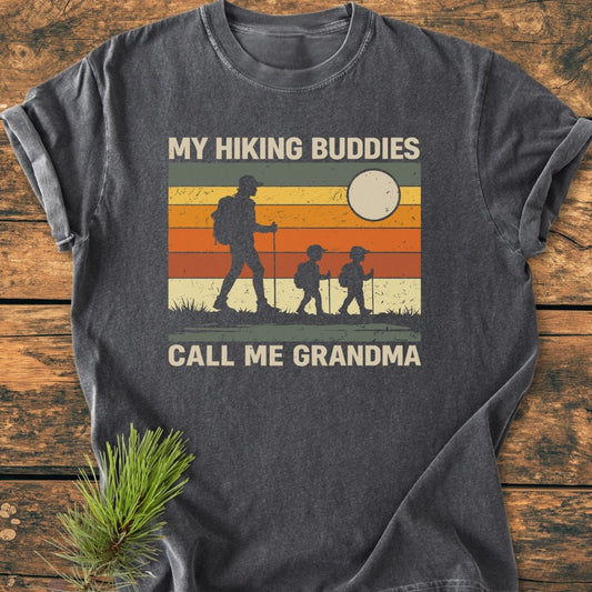 My Hiking Buddies Call Me Grandma - Vintage Wash Tee features a retro-striped sunset with an adult and two kids hiking, perfect for cozy, relaxed daily wear with durable, soft-washed 100% cotton fabric.