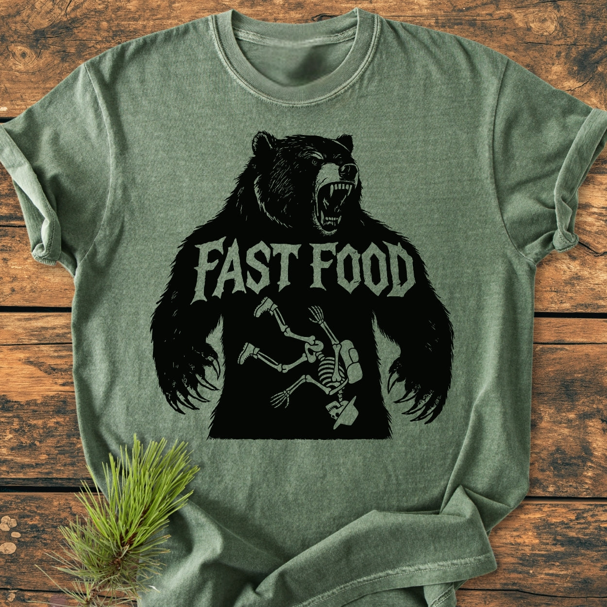 Fast Food - Vintage Wash Tee features a roaring bear silhouette with FAST FOOD text, humorously depicting a hiker's skeleton inside. Soft, relaxed fit, 100% ring-spun cotton, durable stitching.