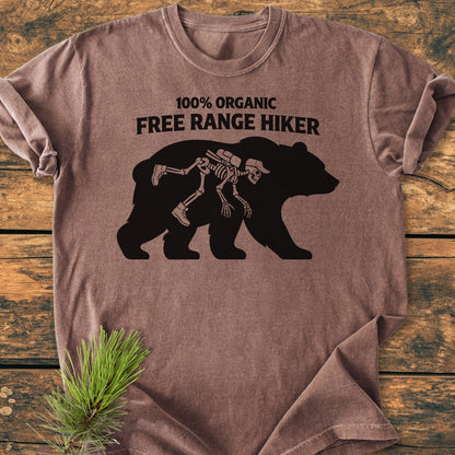 Organic Free Range Hiker - Vintage Wash Tee features a bear silhouette with a hiker skeleton graphic and playful text. Made from soft, durable ring-spun cotton, offering comfort and a relaxed fit.