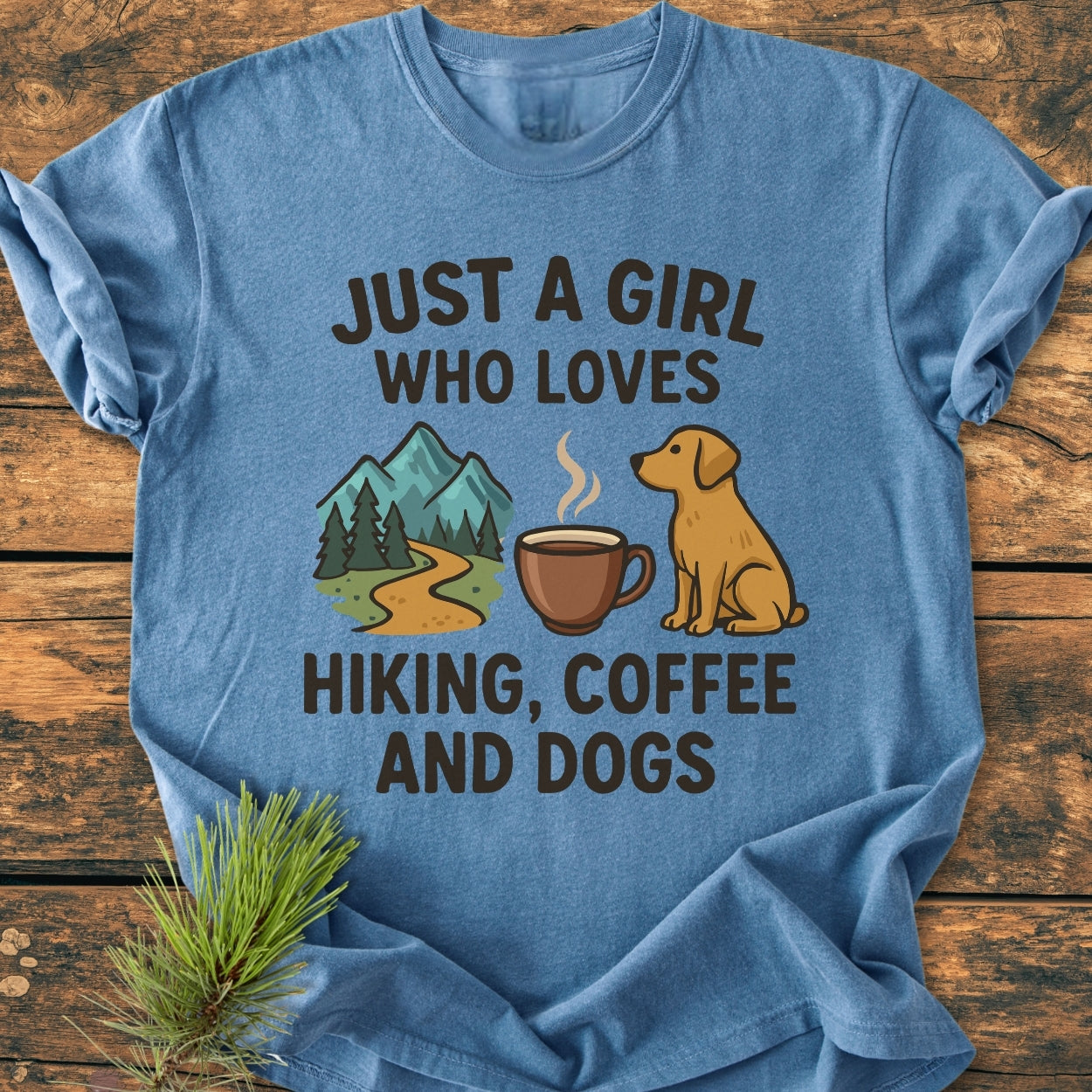 Just A Girl... Hiking Coffee Dogs - Vintage Wash Tee on wooden surface, featuring mountain, coffee mug, and dog icons, highlighting a love for hiking, coffee, and dogs, perfect for daily wear.