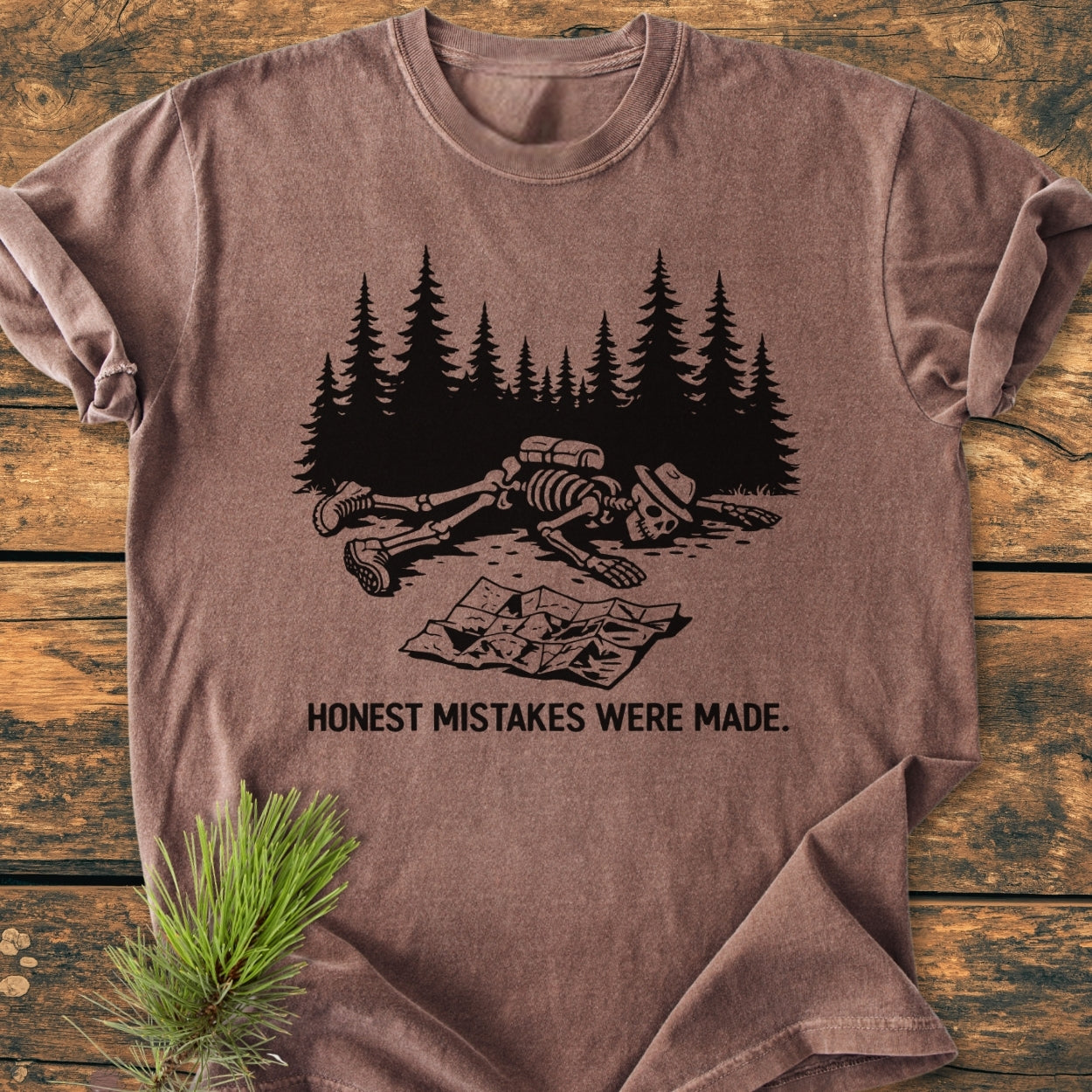 Honest Mistakes Were Made - Vintage Wash Tee features a forest scene with a hiker's skeleton, captioned humorously, on a brown, short-sleeve T-shirt, showcasing durability and comfort from Comfort Colors' garment-dyed collection.