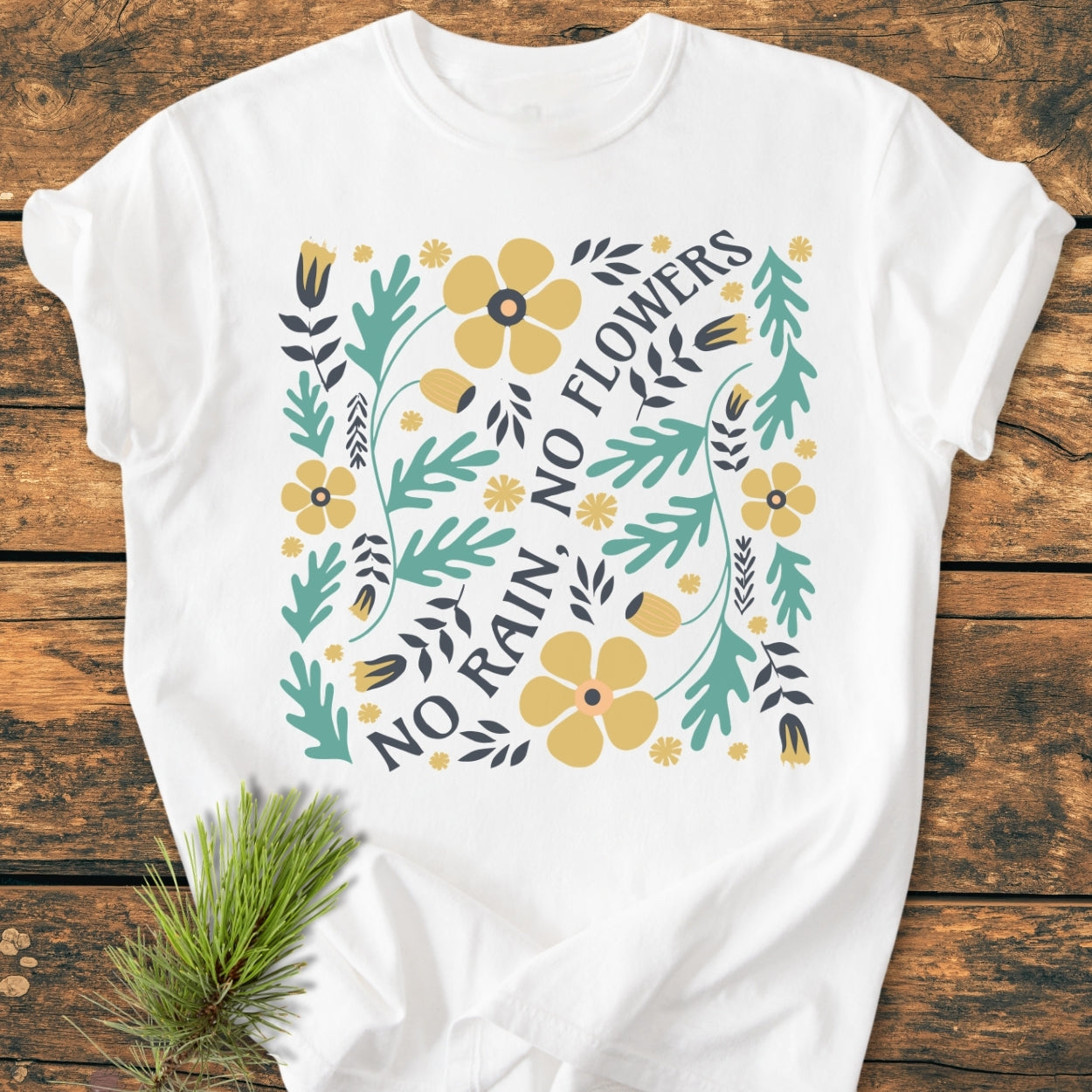 No Rain No Flowers - Vintage Wash Tee features a stylized floral design with yellow blooms and NO RAIN, NO FLOWERS text on a soft, relaxed-fit, white garment-dyed T-shirt, perfect for everyday wear.