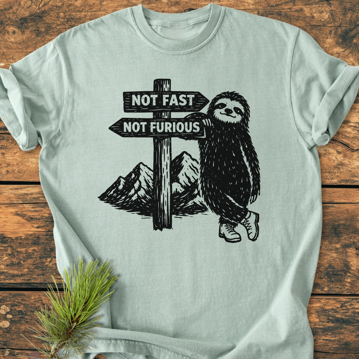 Not Fast Not Furious - Vintage Wash Tee features a sloth in boots by a signpost, offering a cozy, relaxed fit with durable stitching on soft, garment-dyed cotton.