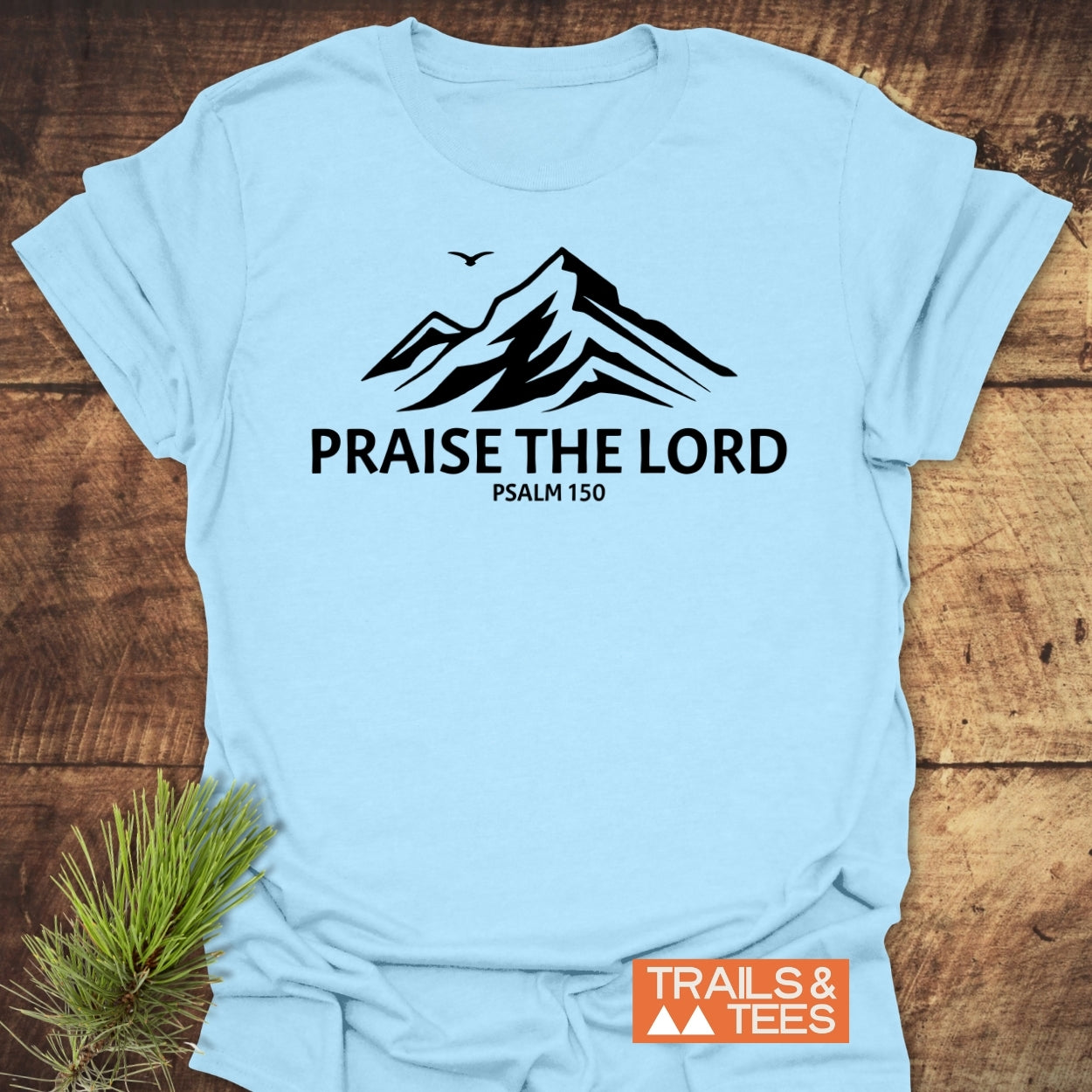 Praise The Lord, Psalm 150 T-Shirt featuring a mountain graphic and bird silhouette. Made from soft ring-spun cotton, designed for comfort and durability. Perfect for outdoor enthusiasts.