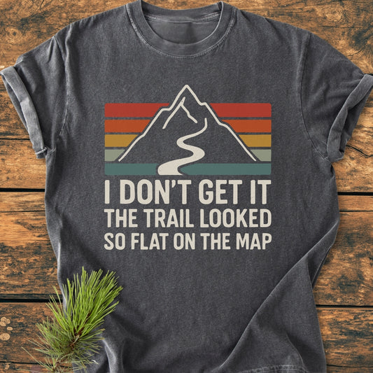 I Don't Get It - Vintage Wash Tee featuring a mountain graphic with retro stripes and a humorous slogan, laid on wood. Made from soft-washed, ring-spun cotton for comfort and durability.