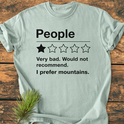 I Prefer Mountains - Vintage Wash Tee: Pale-green T-shirt with 'People' text, 1-out-of-5 star rating, and humorous review. Made of soft, 100% ring-spun cotton, offering comfort and durability in a relaxed fit.