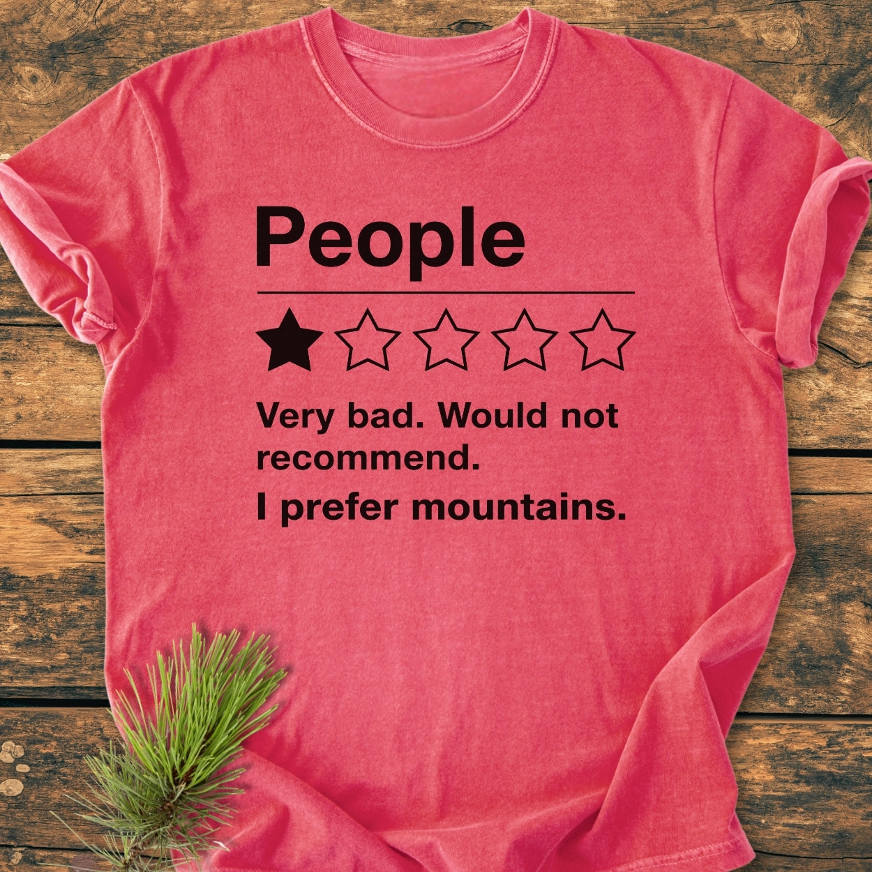 I Prefer Mountains - Vintage Wash Tee displayed on wood, featuring a humorous mock review design, relaxed fit, and durable stitching. Made from pre-shrunk, soft-washed 100% ring-spun cotton.