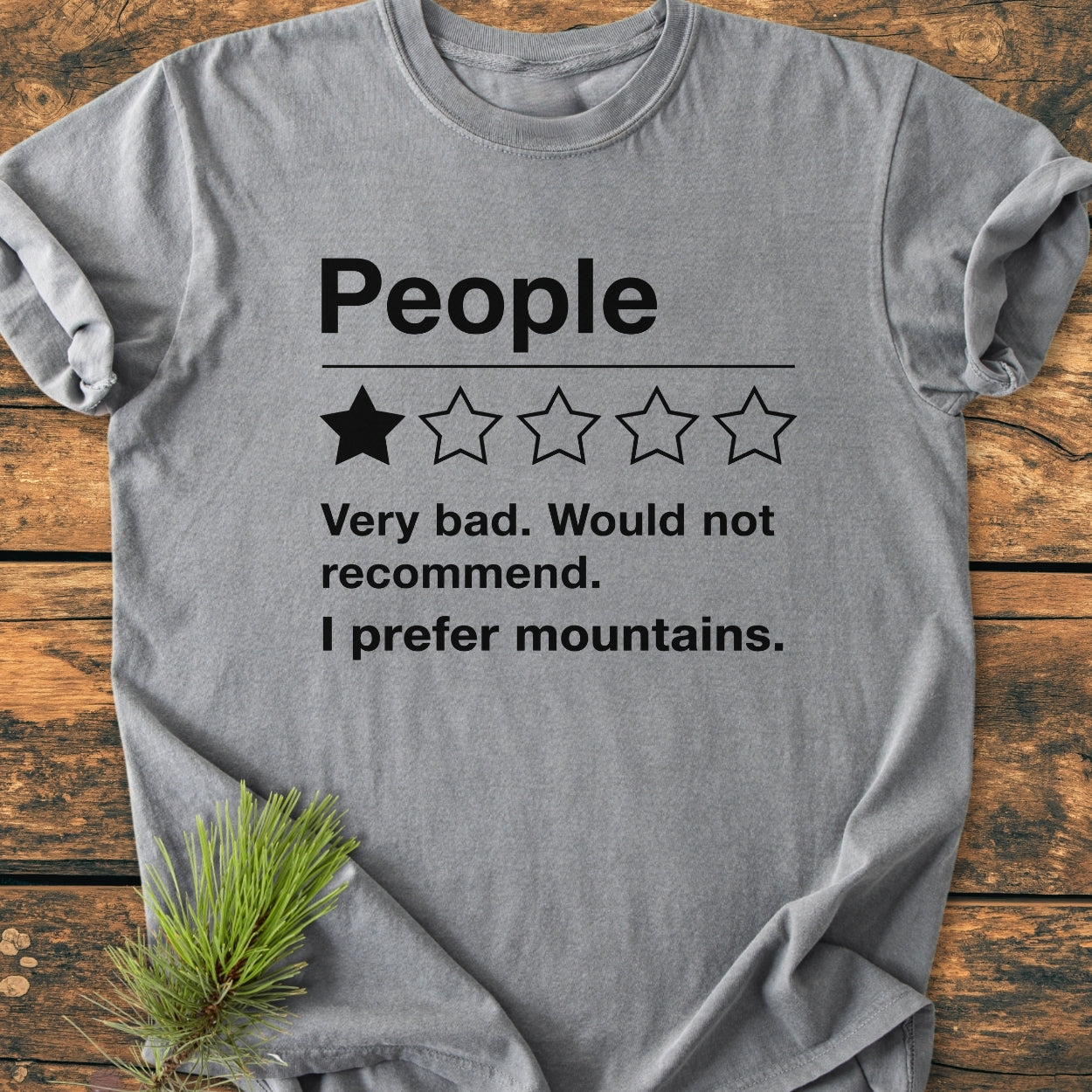 Heather-gray I Prefer Mountains - Vintage Wash Tee on wooden surface, featuring bold People text, 1-star rating, and humorous review. Soft, durable, and relaxed fit, ideal for daily wear.