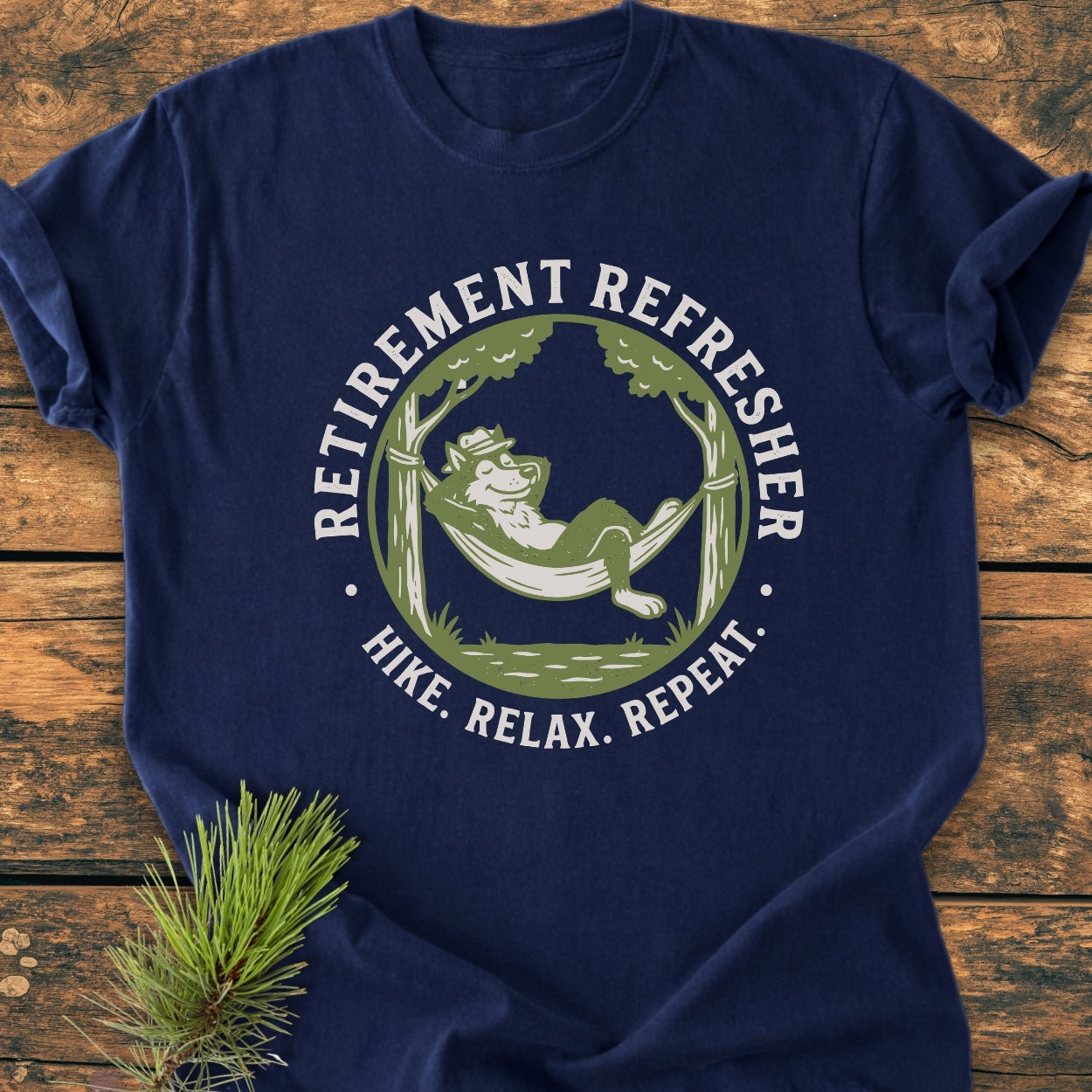 Retirement: Hike. Relax. Repeat - Vintage Wash Tee showcases a bear in a hammock graphic on a navy-blue T-shirt, highlighting comfort and durability with its soft-washed, garment-dyed fabric.