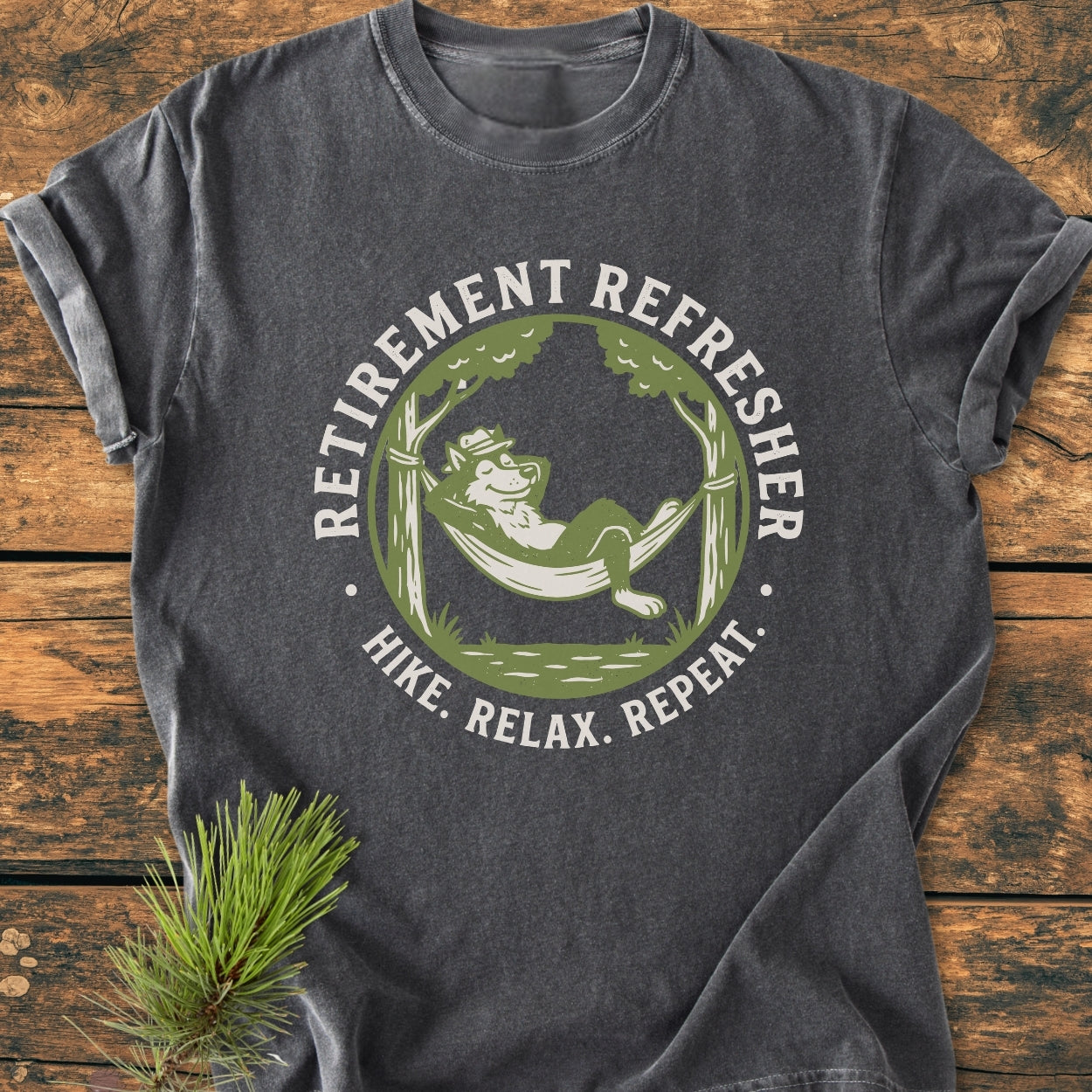 Retirement: Hike. Relax. Repeat - Vintage Wash Tee features a happy wolf or fox in a hammock graphic. The charcoal-gray, ring-spun cotton t-shirt offers a relaxed fit and durable stitching.