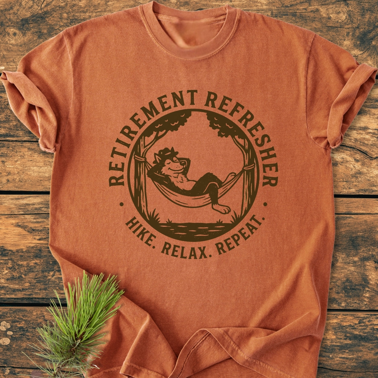 Retirement: Hike. Relax. Repeat - Vintage Wash Tee features a lounging wolf in a hammock graphic, emphasizing outdoor relaxation. Made from pre-shrunk, soft-washed cotton, it offers a cozy, relaxed fit.