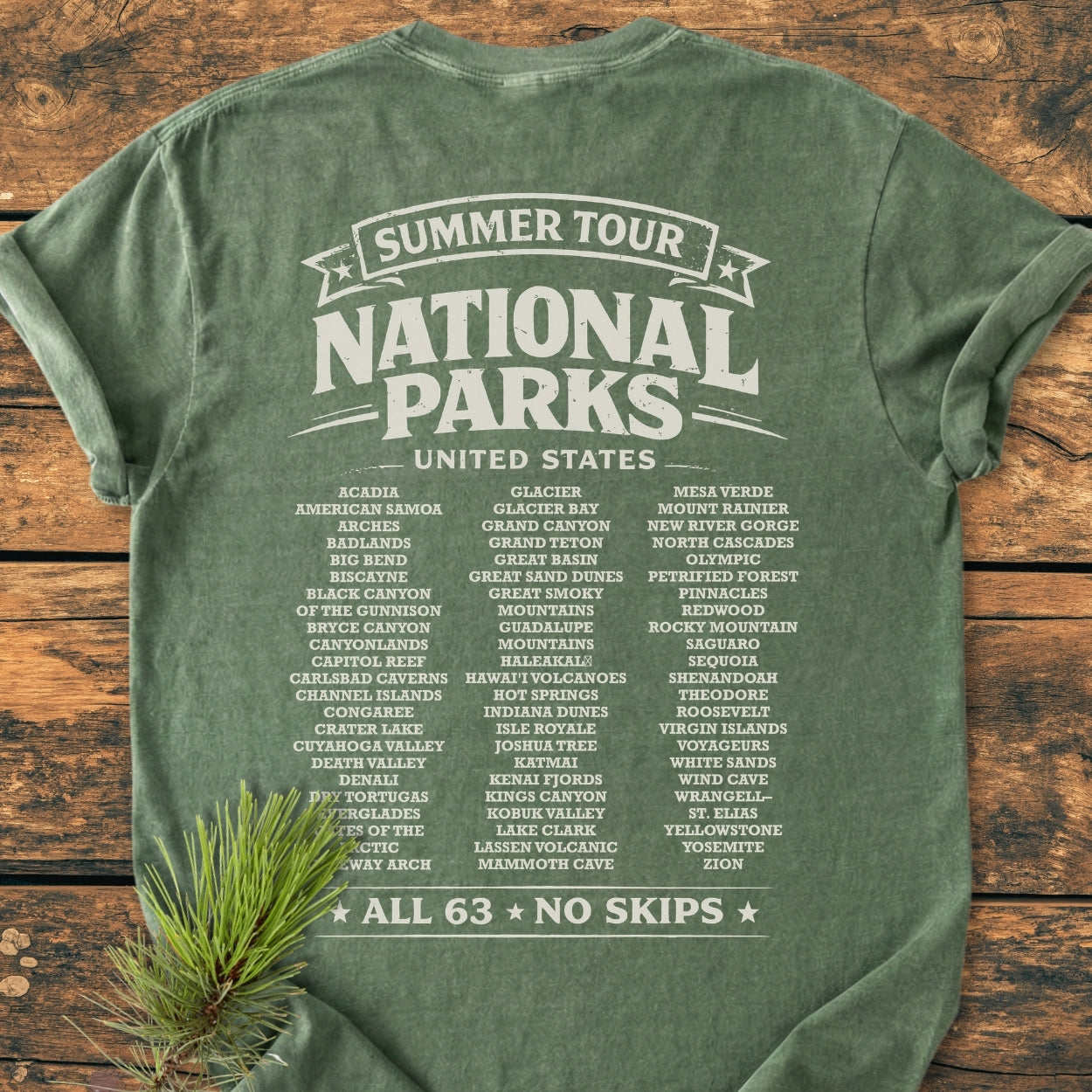Laid-out green Summer Tour National Parks BACK PRINT - Vintage Wash Tee with white text listing all 63 U.S. National Parks, featuring a relaxed fit and soft-washed, garment-dyed fabric for added comfort.