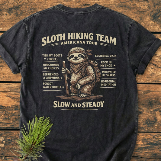 Sloth Hiking Team Tour BACK PRINT - Vintage Wash Tee features a whimsical sloth with a bandana and hiking gear, surrounded by a playful checklist, on a soft, durable garment-dyed T-shirt.
