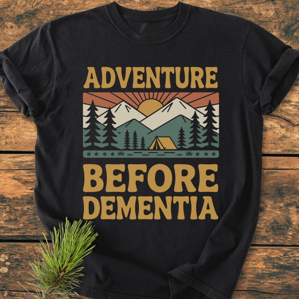 Adventure Before Dementia - Vintage Wash Tee features a retro outdoor scene with mountains and a tent, printed on a black, soft-washed, relaxed fit T-shirt for cozy, durable everyday wear.
