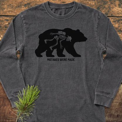 Mistakes Were Made Long-Sleeve Tee features a black bear silhouette with a hiker's skeleton inside, captioned “MISTAKES WERE MADE.” Made from soft, 100% ring-spun cotton for a relaxed, comfortable fit.