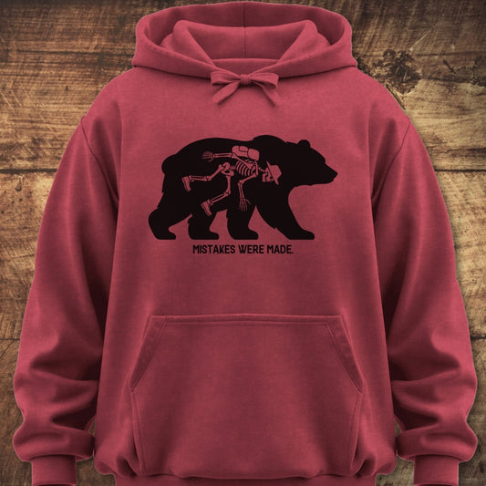 Mistakes Were Made Hoodie featuring a walking bear silhouette with a hiker skeleton inside, crafted from garment-dyed cotton blend for a relaxed fit, perfect for trail adventures and cozy nights.
