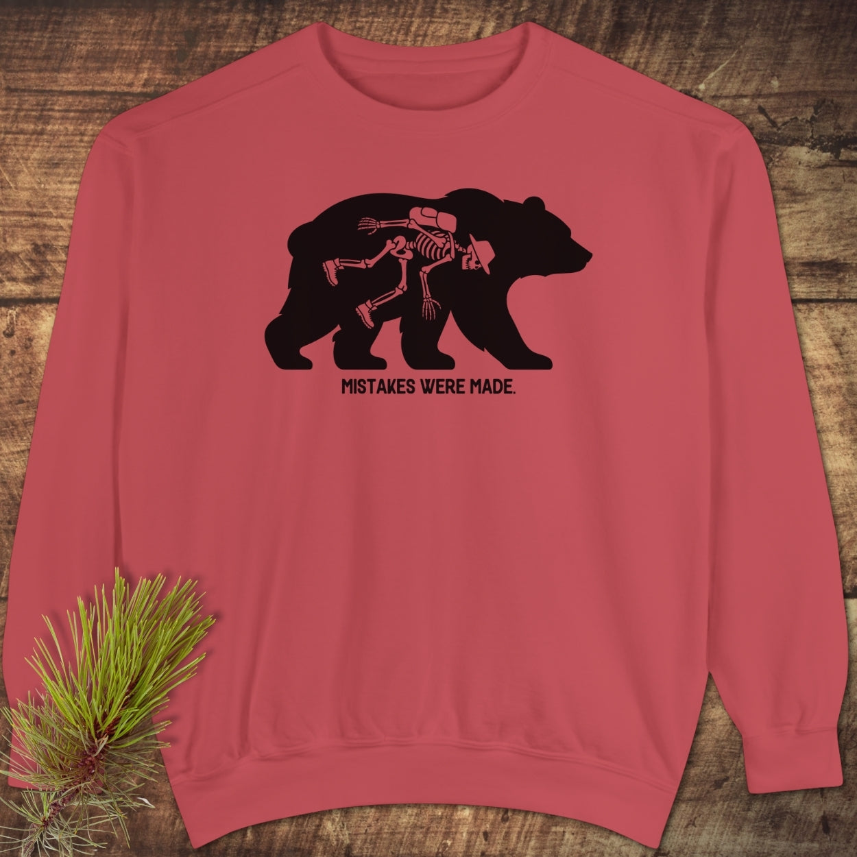 Mistakes Were Made Sweatshirt featuring a black bear silhouette with a hiker's skeleton inside. Unisex, garment-dyed with a relaxed fit, emphasizing luxurious comfort and style.