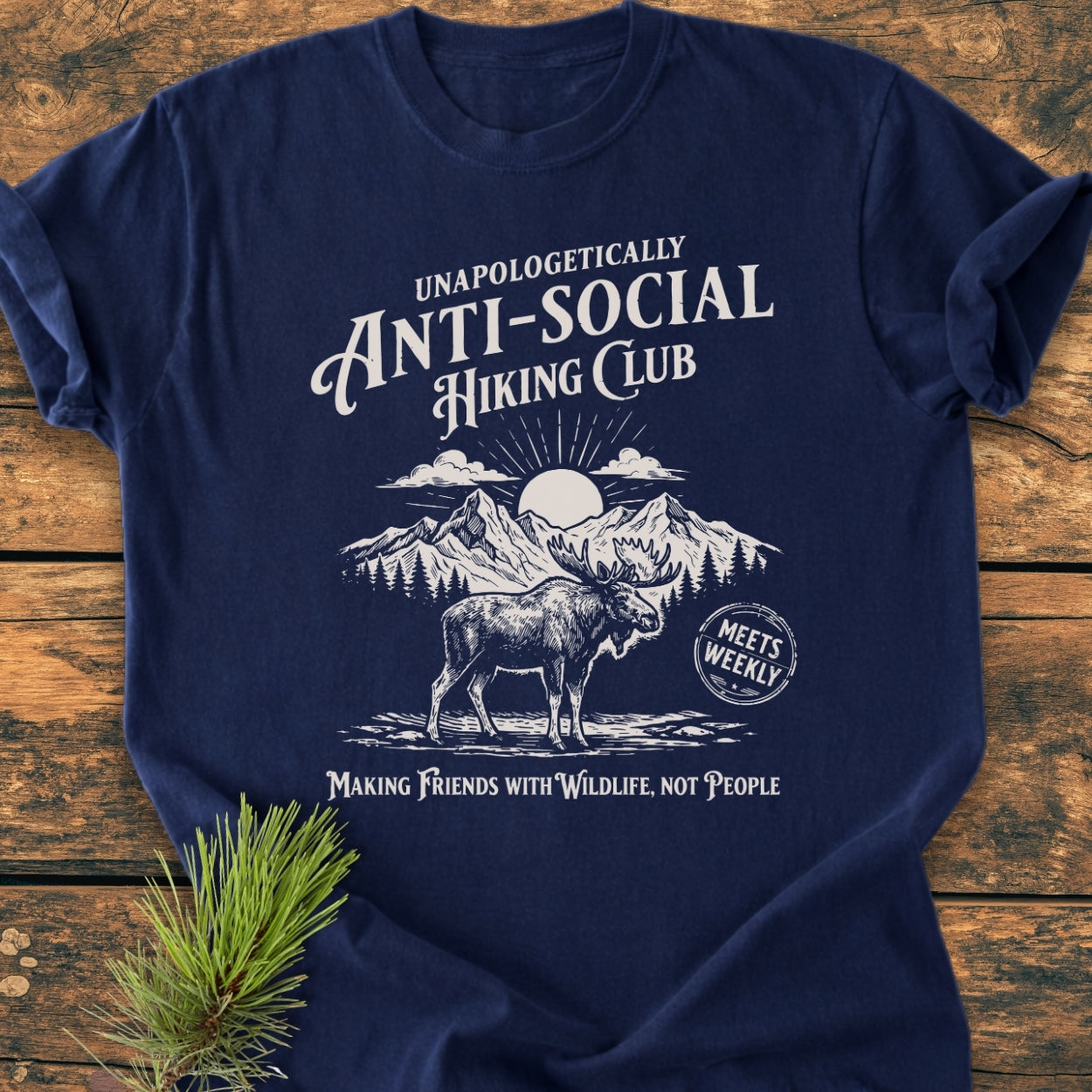 Anti-Social Hiking Club - Vintage Wash Tee featuring a moose and mountain graphic with the slogan Making Friends with Wildlife, Not People on a navy-blue Comfort Colors T-shirt, laid flat on wood.
