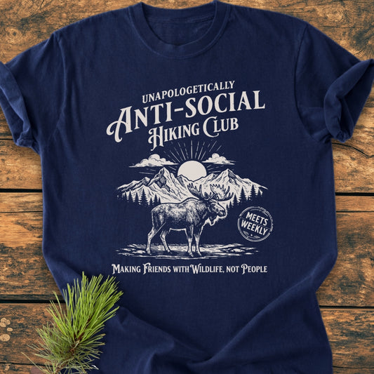 Anti-Social Hiking Club - Vintage Wash Tee featuring a moose and mountain graphic with the slogan Making Friends with Wildlife, Not People on a navy-blue Comfort Colors T-shirt, laid flat on wood.