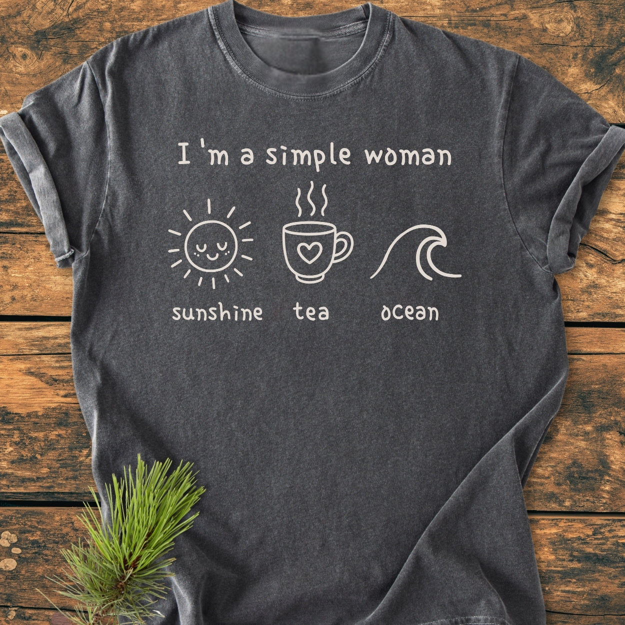 I'm A Simple Woman - Sunshine Tea Ocean - Vintage Wash Tee laid flat, featuring off-white graphics of a sun, teacup, and wave, on a cozy charcoal-gray Comfort Colors 1717 T-shirt.