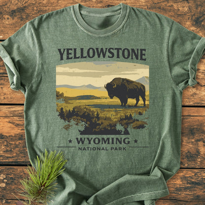 Yellowstone - Vintage Wash Tee features a stylized bison scene with YELLOWSTONE text, laid on rustic wood. Crafted from soft, durable 100% ring-spun cotton, perfect for everyday comfort.