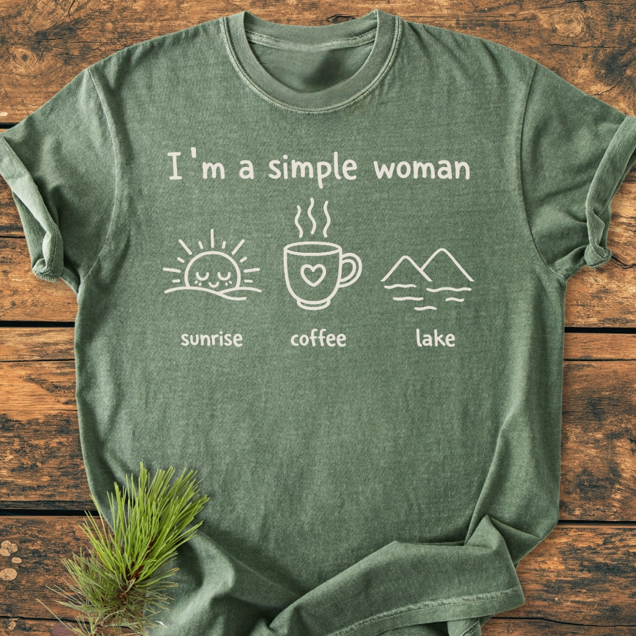 Heather-green I'm A Simple Woman - Sunrise Coffee Lake - Vintage Wash Tee laid flat, showcasing line-drawn icons of sunrise, coffee, and lake on chest, emphasizing its relaxed fit and garment-dyed softness.