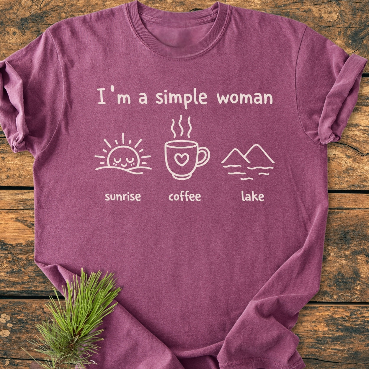 I'm A Simple Woman - Sunrise Coffee Lake - Vintage Wash Tee features white line-art icons of a sunrise, coffee mug, and lake on a purple-heather, laid-flat, 100% ring-spun cotton shirt.