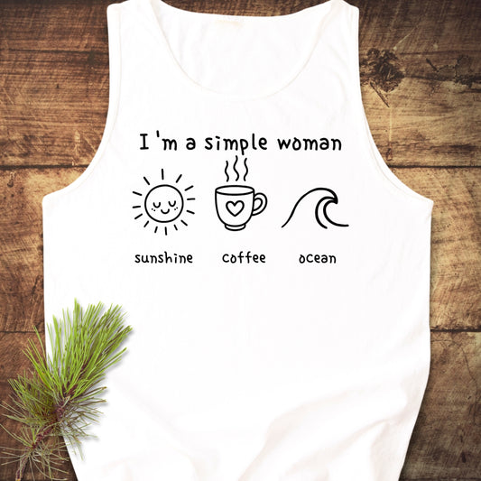 I'm A Simple Woman - Sunshine Coffee Ocean Tank Top displayed on wood, featuring a white tee with black line drawings of a sun, coffee cup, and ocean wave, symbolizing simplicity and sustainability.