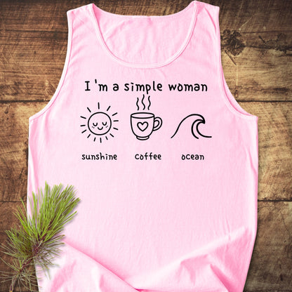 I'm a Simple Woman - Sunshine Coffee Ocean Tank Top featuring black text and icons of a sun, coffee mug, and ocean wave, laid flat on a wooden surface.