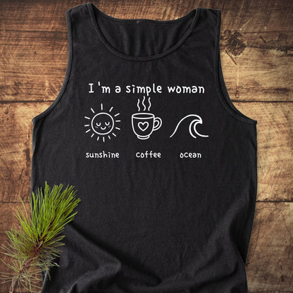 I'm A Simple Woman - Sunshine Coffee Ocean Tank Top featuring white print icons and text on a black shirt, laid on a wooden surface with a pine sprig, showcasing comfort and sustainability.