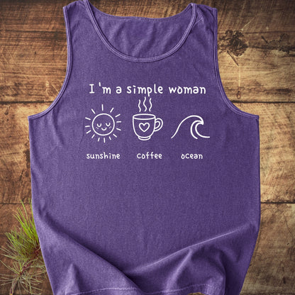 I'm A Simple Woman - Sunshine Coffee Ocean Tank Top on wooden surface, featuring white text with icons of a sun, coffee mug, and wave, emphasizing comfort and sustainability with its 100% US cotton fabric.