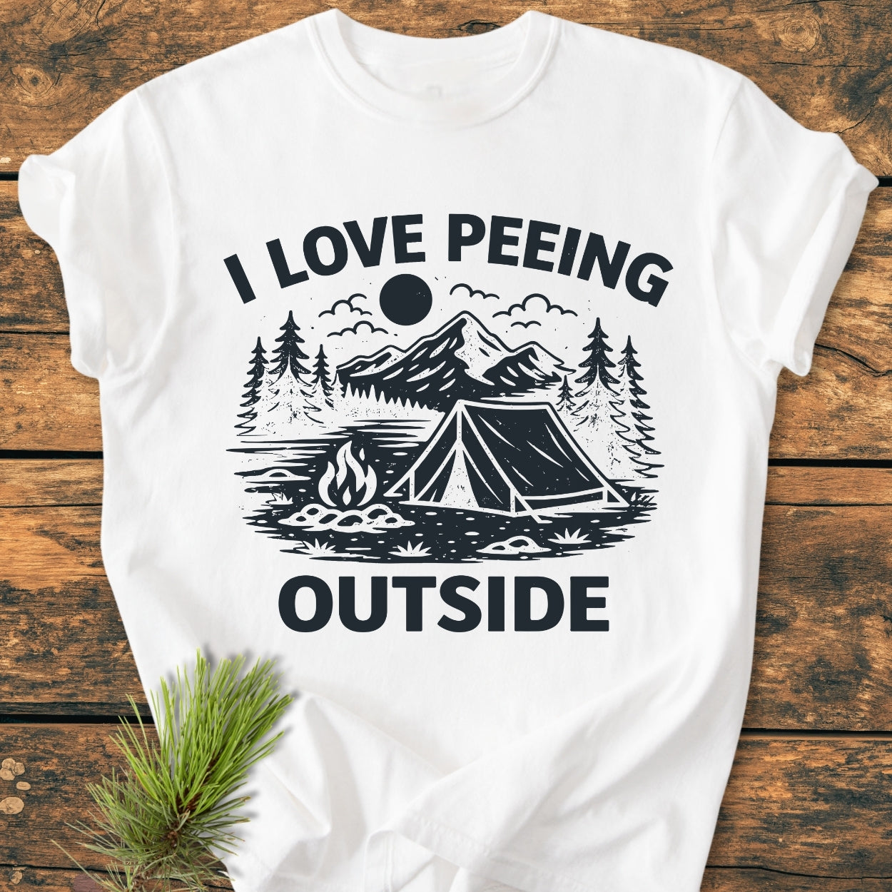 I Love Peeing Outside - Vintage Wash Tee: White T-shirt with a stylized camping scene, featuring mountains, trees, a tent, and campfire, paired with bold text. Made of garment-dyed, soft-washed ring-spun cotton.