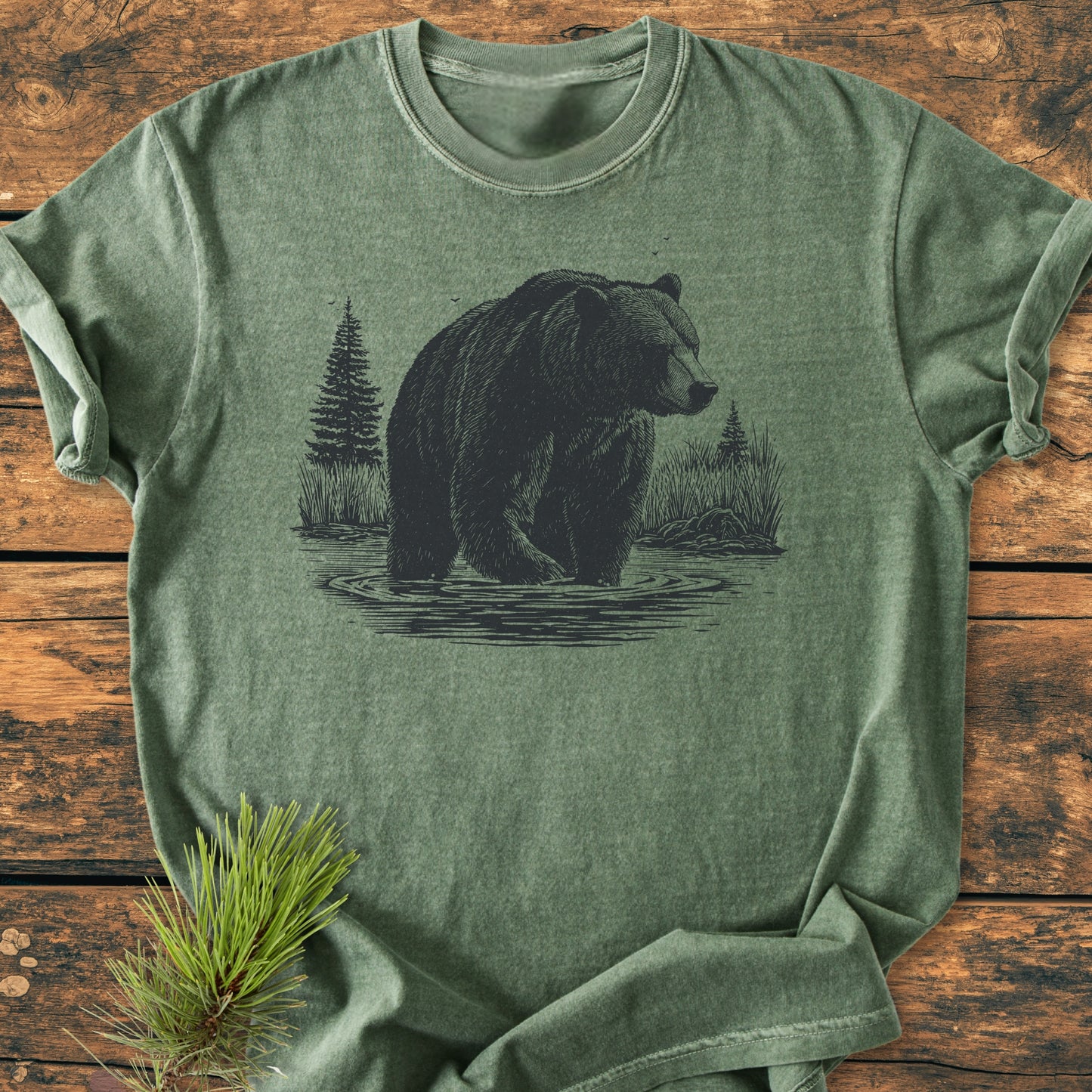 Majestic Grizzly - Vintage Wash Tee features a hand-drawn bear illustration in water, laid flat with a pine sprig accent, showcasing its relaxed fit and durable craftsmanship.