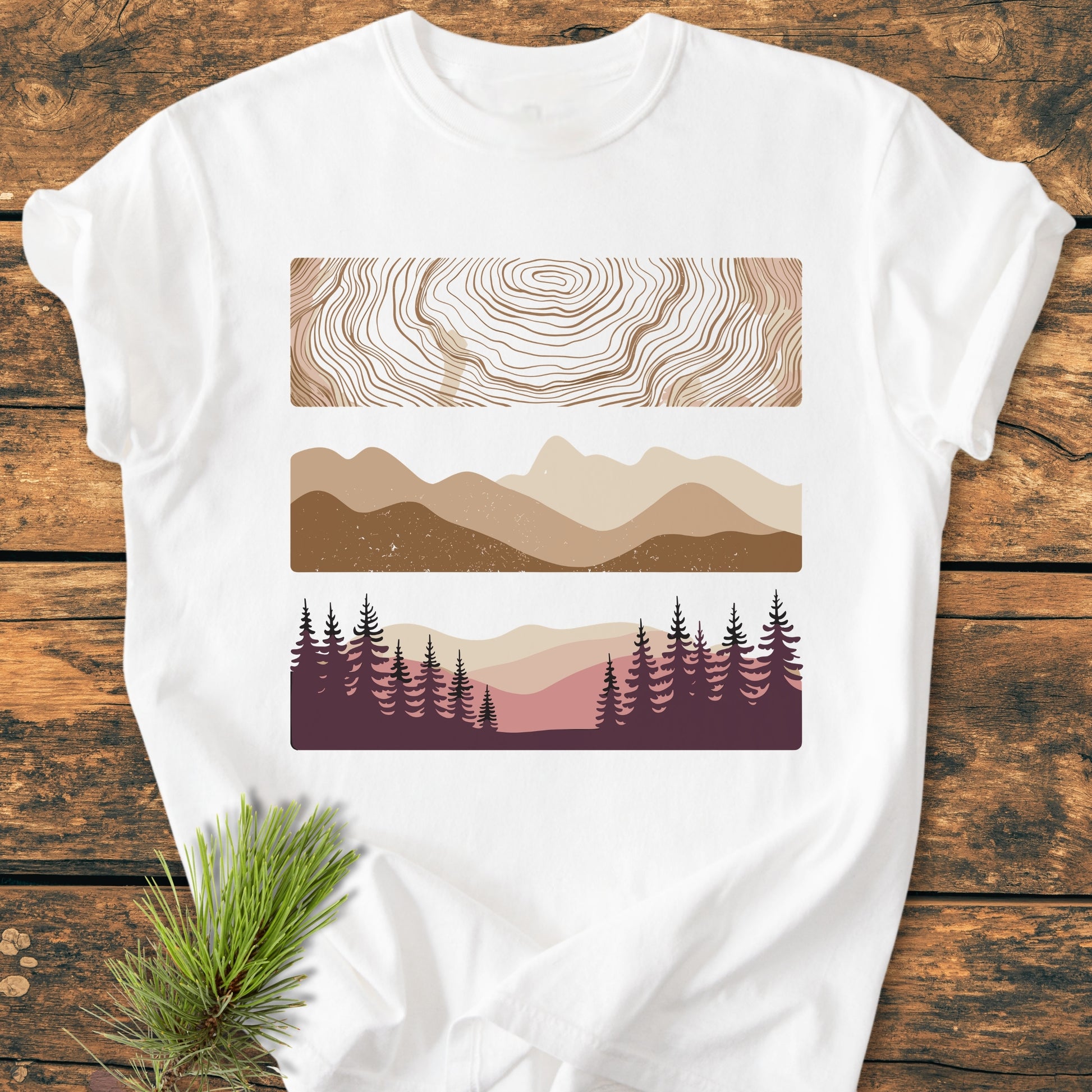 Minimalist Mountain Graphic - Vintage Wash Tee on a rustic surface, featuring topographic lines, mountain silhouettes, and a forest scene, printed on soft, durable Comfort Colors garment-dyed cotton.
