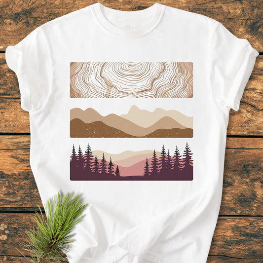 Minimalist Mountain Graphic - Vintage Wash Tee on a rustic surface, featuring topographic lines, mountain silhouettes, and a forest scene, printed on soft, durable Comfort Colors garment-dyed cotton.
