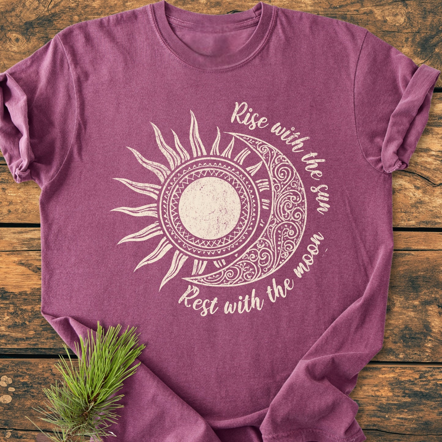 Sun & Moon Mystical Boho - Vintage Wash Tee features a stylized sun/moon graphic with Rise with the sun, Rest with the moon text. A pine sprig accents the mauve T-shirt's cozy, relaxed fit.
