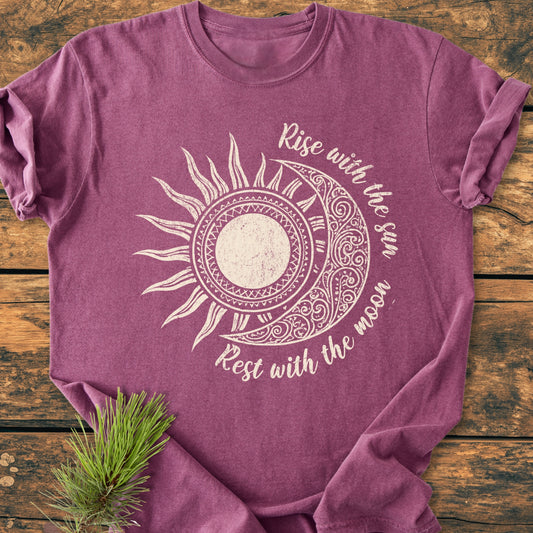 Sun & Moon Mystical Boho - Vintage Wash Tee features a stylized sun/moon graphic with Rise with the sun, Rest with the moon text. A pine sprig accents the mauve T-shirt's cozy, relaxed fit.
