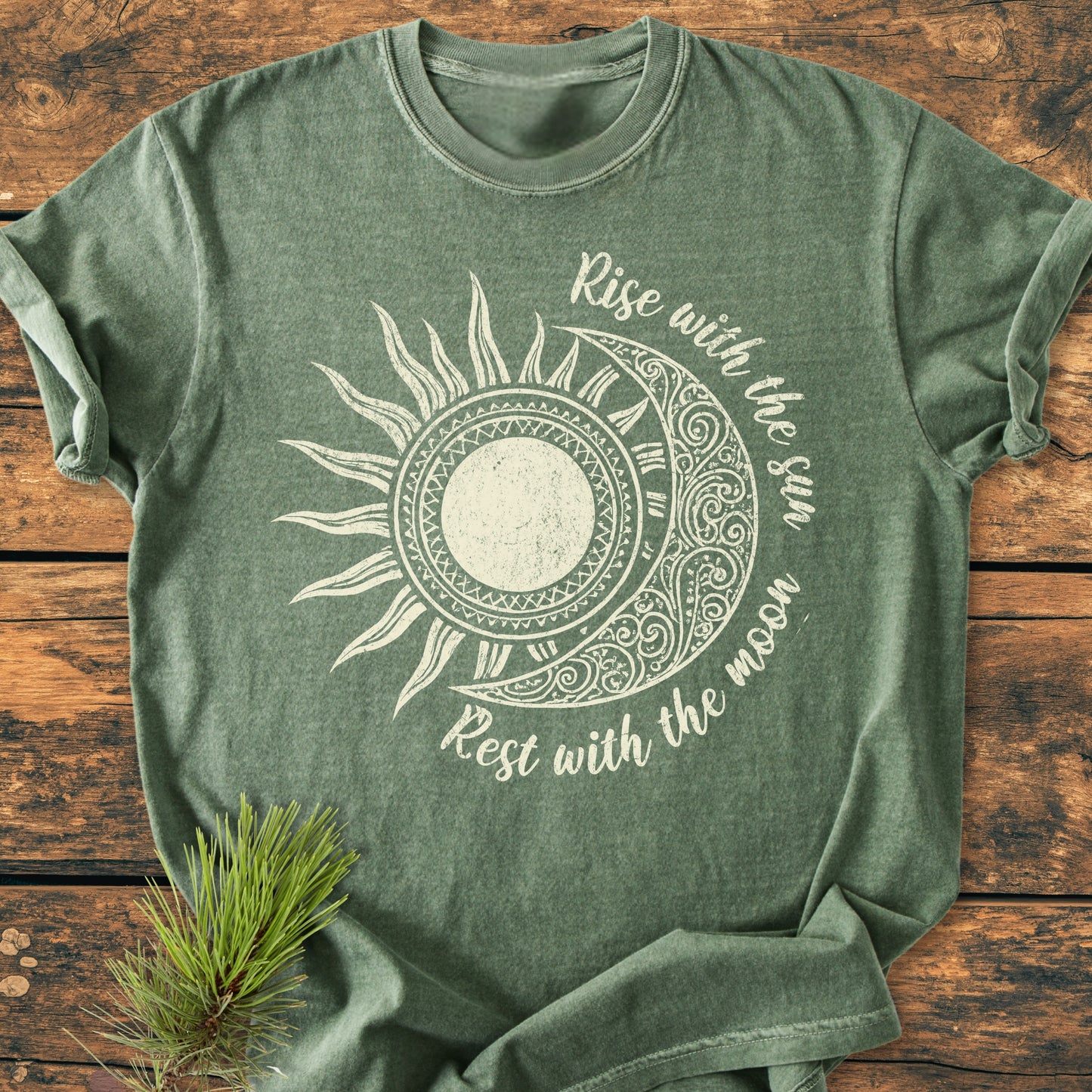 Sun & Moon Mystical Boho - Vintage Wash Tee laid flat, features a stylized sun and moon graphic with Rise with the sun – Rest with the moon slogan, enhancing its boho charm.