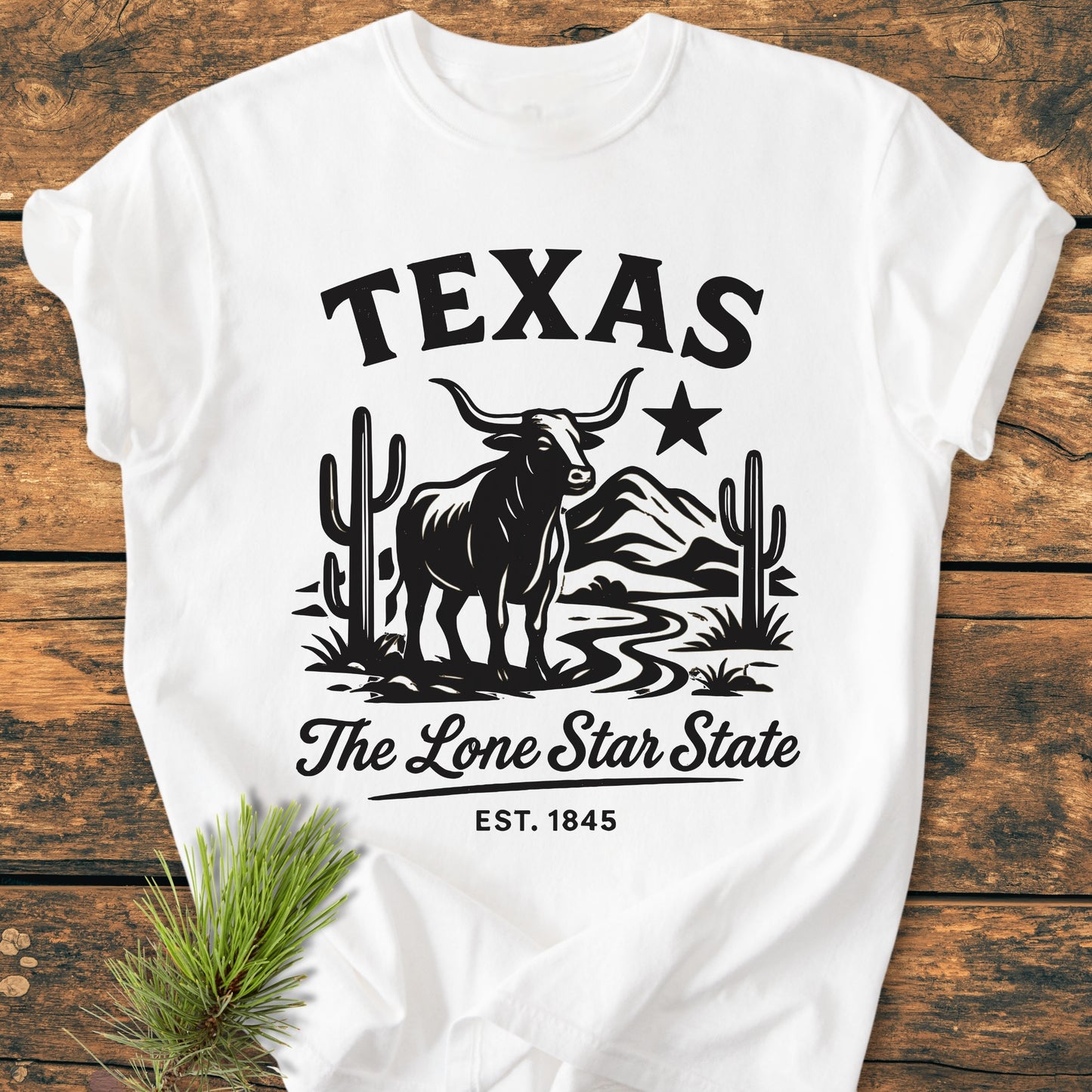 Texas, The Lone Star State - Vintage Wash Tee features a bold black graphic of a longhorn steer, saguaro cacti, and TEXAS text, celebrating Texas identity on a white, relaxed-fit T-shirt.