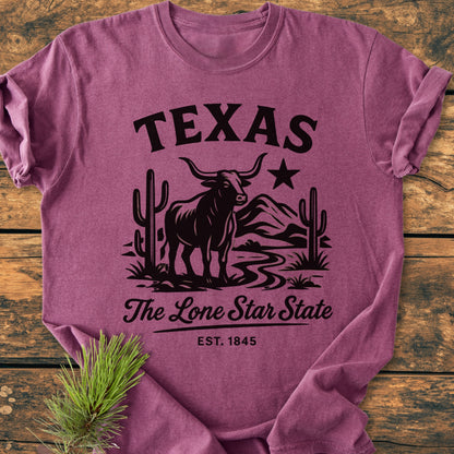 Texas, The Lone Star State - Vintage Wash Tee: Heathered purple T-shirt featuring a longhorn steer graphic, TEXAS, and The Lone Star State script. A pine branch accents the shirt's corner.