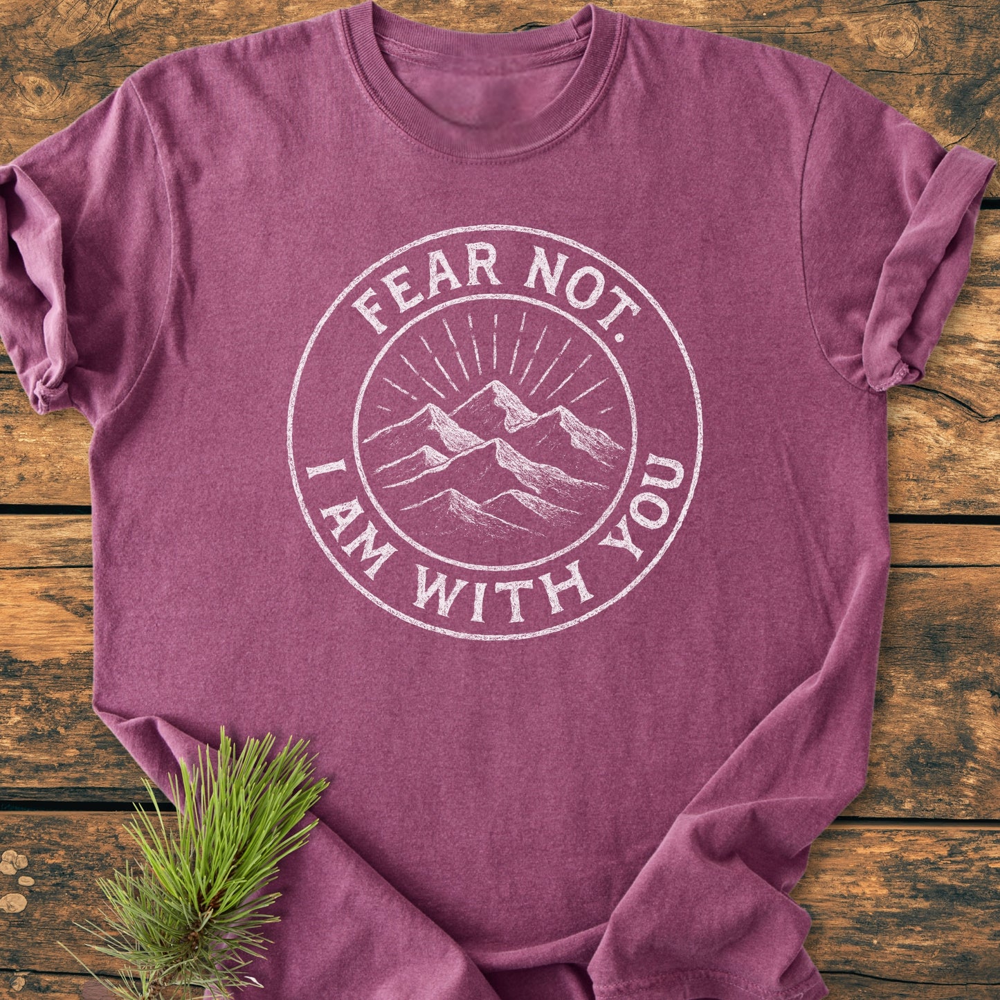 Fear Not - Vintage Wash Tee in plum-purple with white mountain emblem and text, displayed on wood. Features a relaxed fit, soft-washed, garment-dyed fabric, highlighting its comfort and durability.