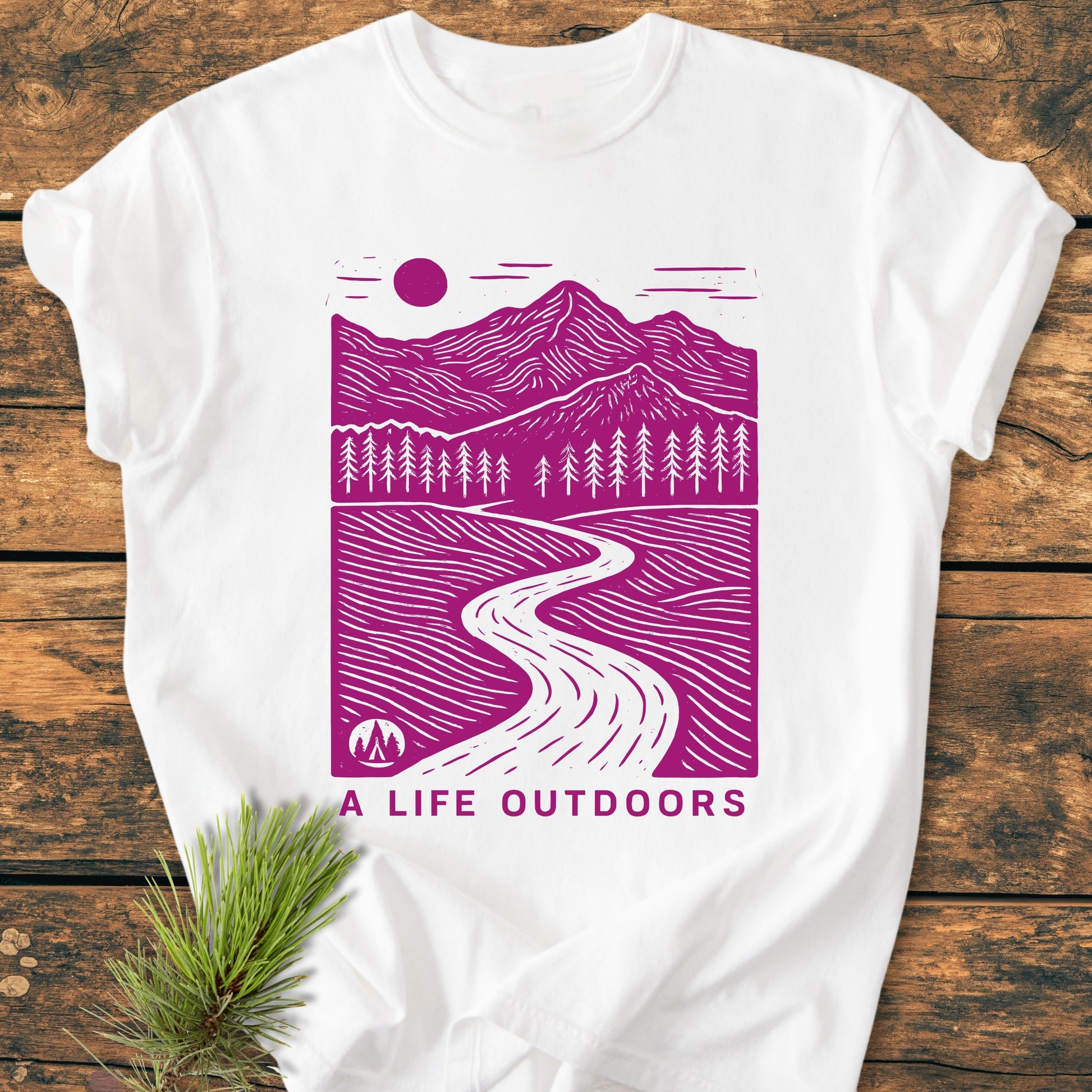 A Life Outdoors - Vintage Wash Tee features a purple outdoor scene with mountains, trees, and a river, on a white, soft-washed, garment-dyed T-shirt, highlighting comfort and durability.