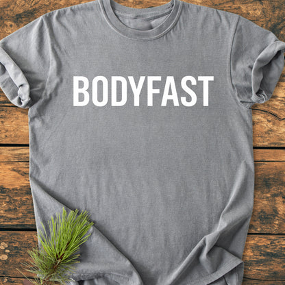 BODYFAST - Vintage Wash Tee: Soft gray T-shirt with bold white BODYFAST lettering, styled with a pine branch. A wearable reminder of a healthier, balanced lifestyle.