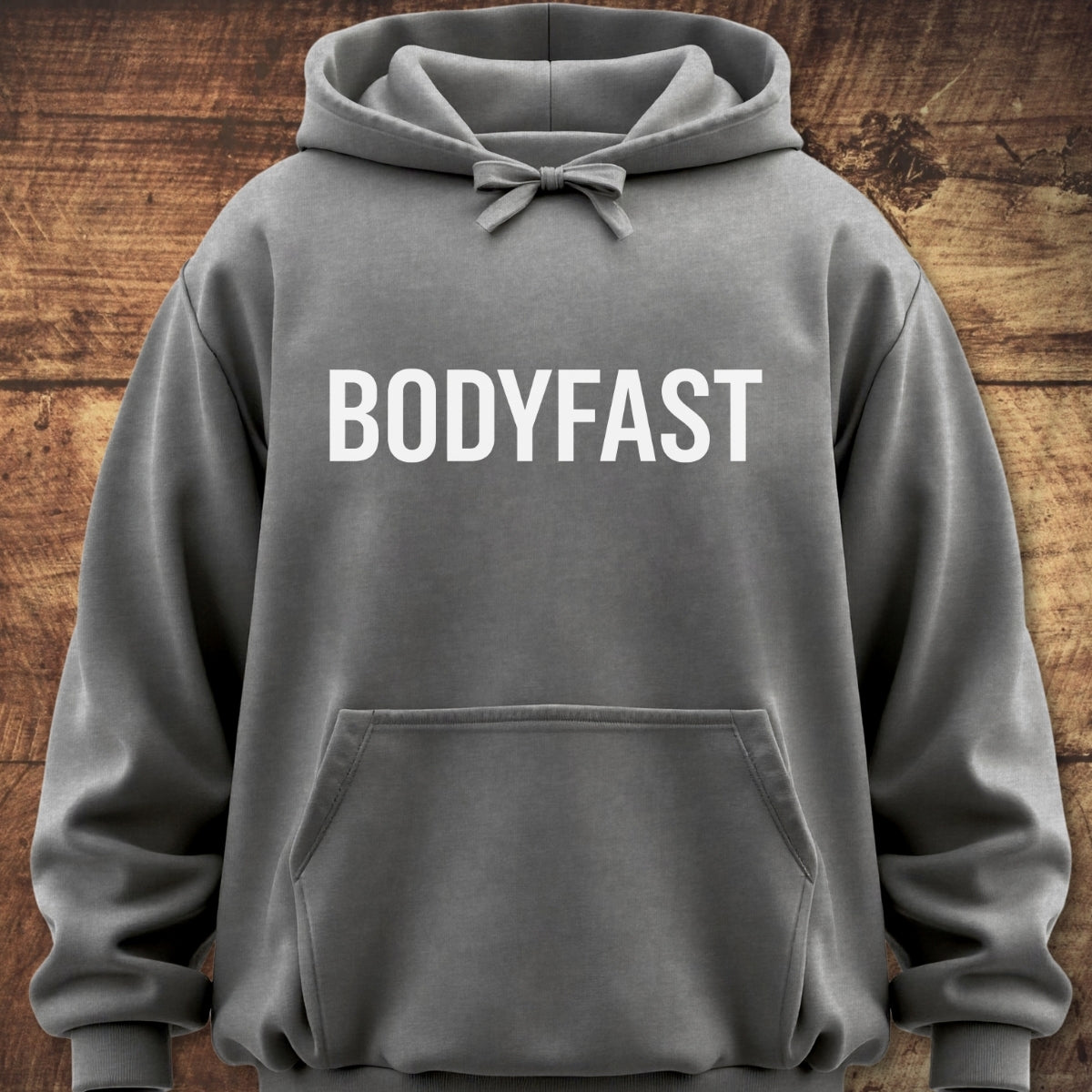 Gray BODYFAST Hoodie with white lettering across the chest, featuring a kangaroo pocket and jersey-lined hood. Made from garment-dyed cotton/polyester fleece for a relaxed, vintage look.